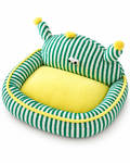 A plush pet bed with a green and white striped exterior, a bright yellow interior cushion, and small yellow pom-pom accents on the top, shown on a clean white background.