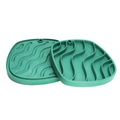Two green silicone mats with wavy patterns on a white background