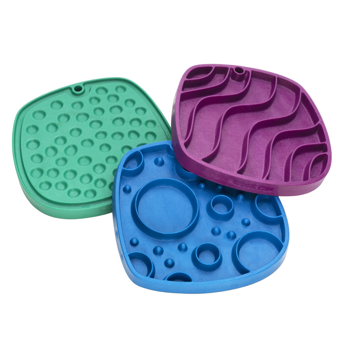 Three colorful silicone mats with different textures on a white background