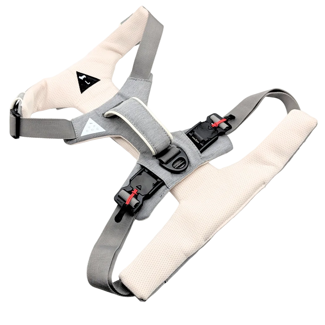 Gray and beige dog harness on a white background