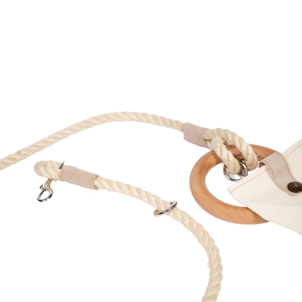 Close-up of a beige rope with wooden rings on a white background